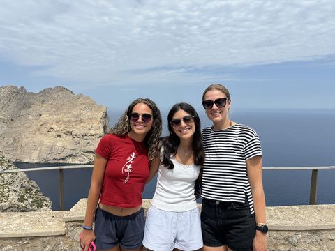 High schoolers standing above ocean on study abroad day trip