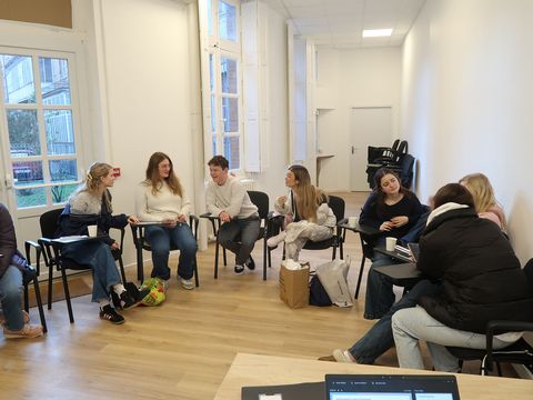 Students in classroom in discussion groups
