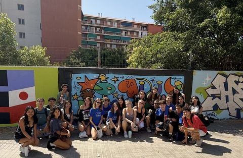 CIEE students posing in front of their beautiful piece of art