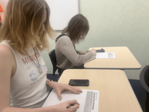 student drawing at manga class
