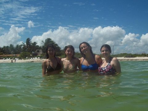 Four students in the water looking at the camera