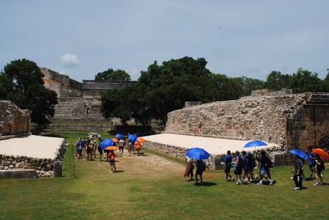Students walk through the Pok ta Pok ball court