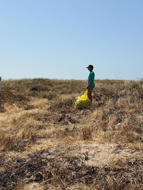 high school student cleaning up beach in Lisbon