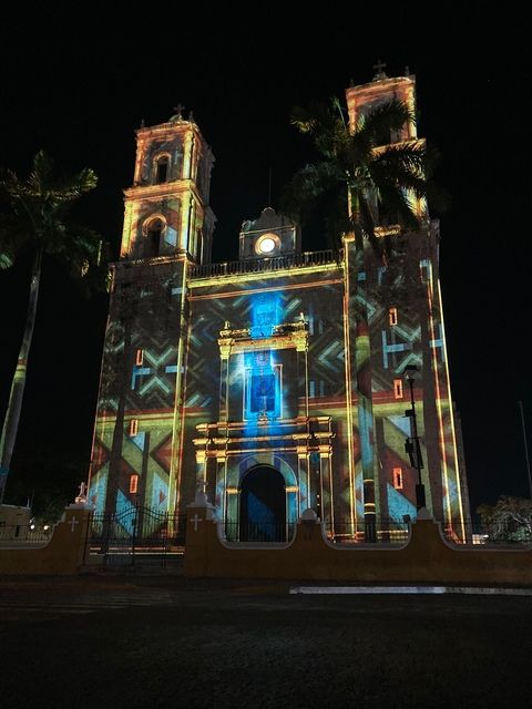 A photo of a cathedral with video projections on it