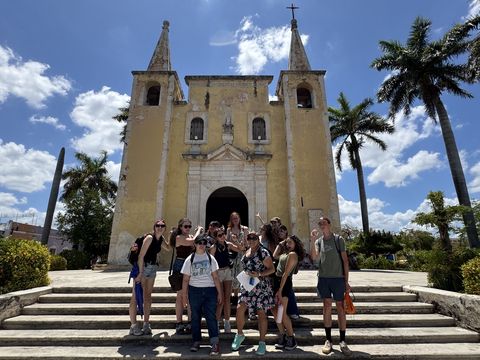 Students in the Yucatan standing in front of a church