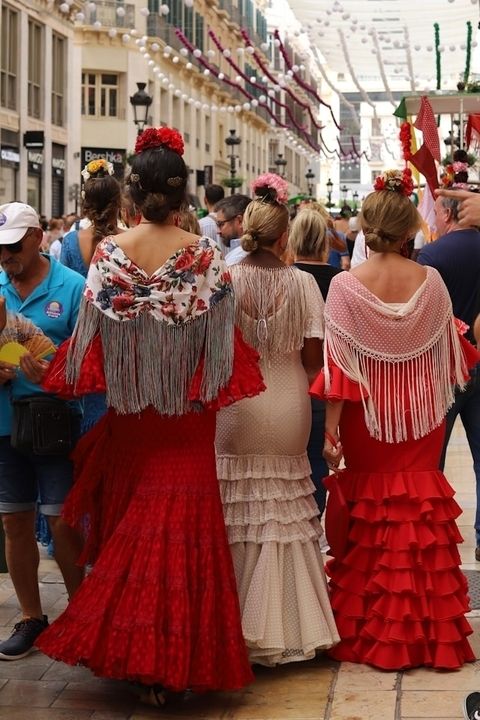 Women dressed in flamenco dresses during the Malaga feria