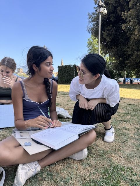 high school students studying outside while abroad
