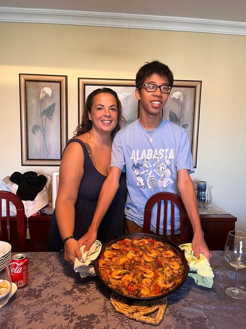 Student and host parent showing off meal they cooked together