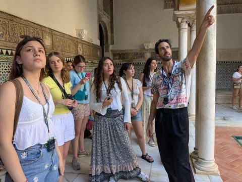 Teens touring a historic building in Spain while studying abroad