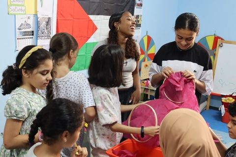 Teen on service program helping local children in classroom 