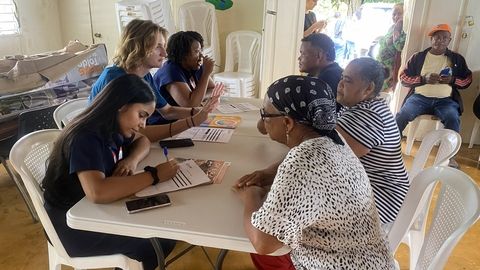 public health program participants filling out paperwork for locals