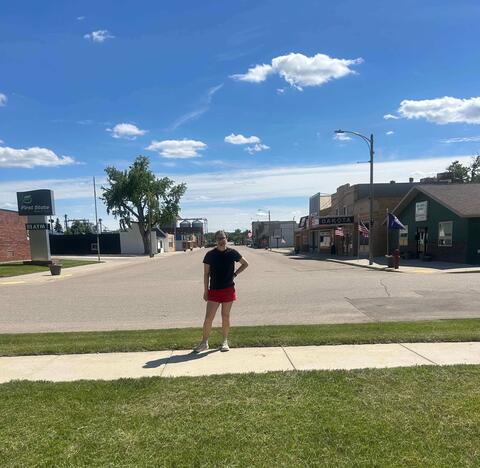 Hannah W. stands on her North Dakota city's main street.