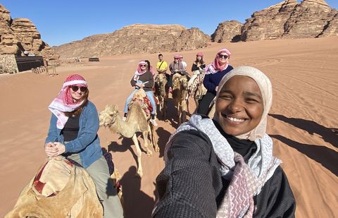 students ride camels abroad amman jordan