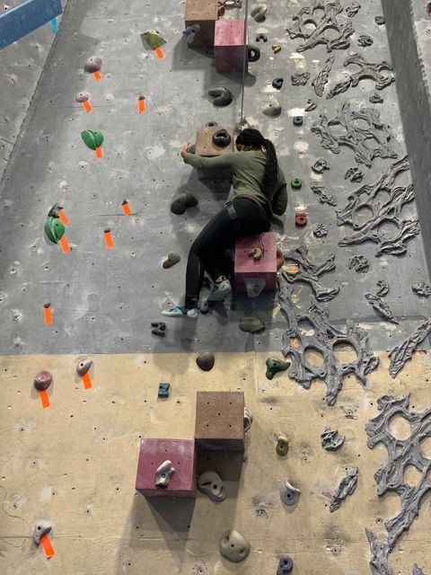 A BridgeUSA High School participant takes on an indoor rock climbing wall.