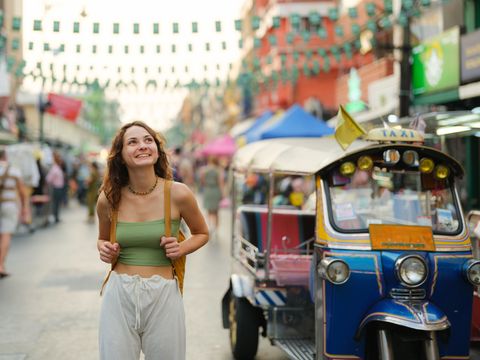 Cheerful Woman Exploring Khao San Road in Bangkok