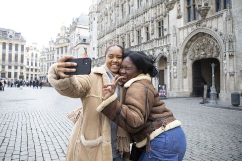 Two sisters having a fun day out together in Brussels city center in springtime