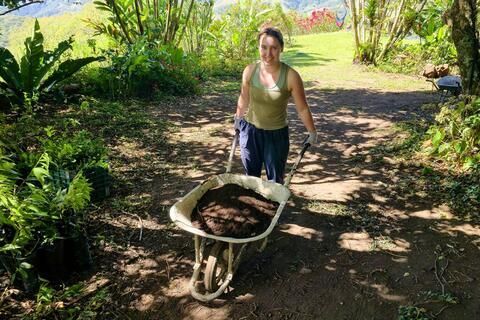 monteverde-ccii-female-student-pushing-wheelbarrow-on-farm