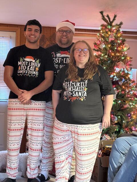 The Johnstons stand with exchange student Cem in traditional holiday pajamas at Christmastime.