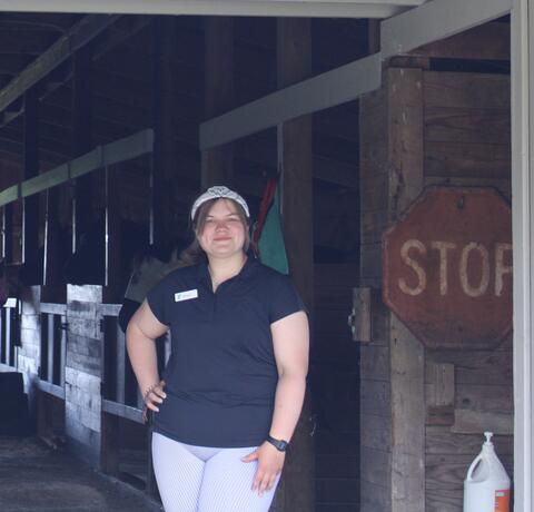 Venla S. poses in the camp barn
