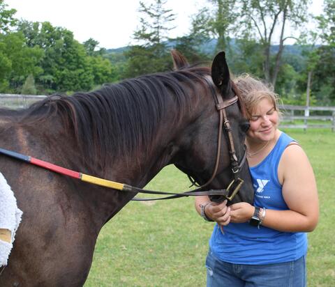 Venla S. of Finland gets close to one of the summer camp's horses.