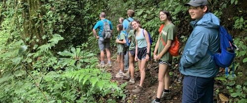 Students hiking in the green mountains of Monteverde