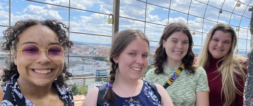 Smiling high school students on lock bridge in Prague