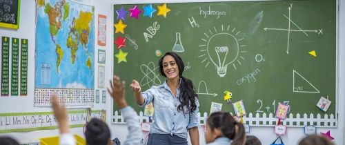 Teacher in front of class teaching her students