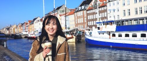 Copenhagen girl with coffee by river