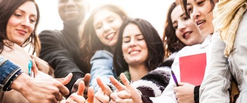 Group of students taking a selfie outside on a sunny day