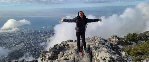 High school student at the top of a mountain in Cape Town