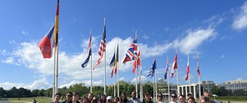 students in paris visiting flag place