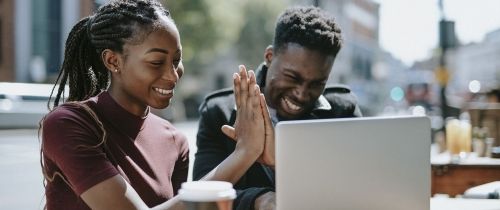 two students high five each other