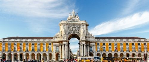 lisbon plaza with archway and yellow building