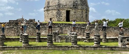 yucatan students standing ruins