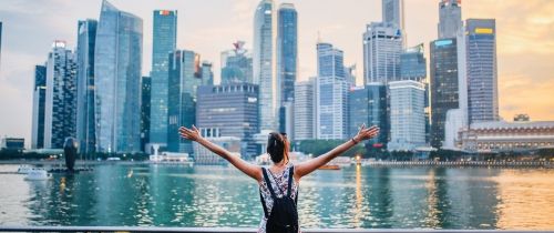 singapore girl on boat overlooking harbor and city