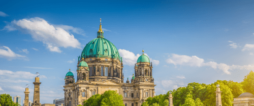 Berlin Cathedral with boat going under bridge.