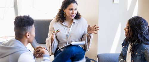 high school counselor meeting with two students