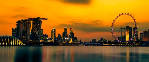 singapore skyline and ferris wheel at sunset