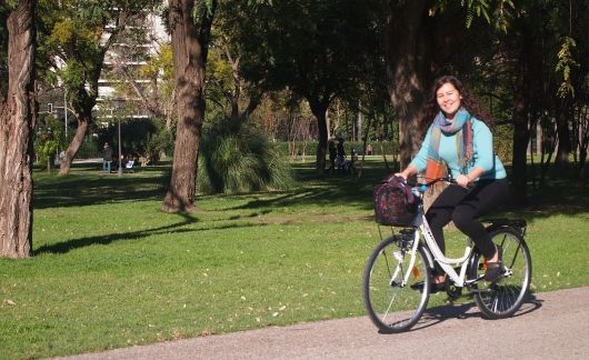 Student bike riding in a Seville park