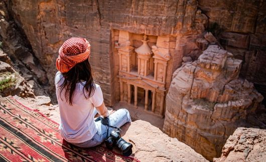 Student with camera sitting above Petra