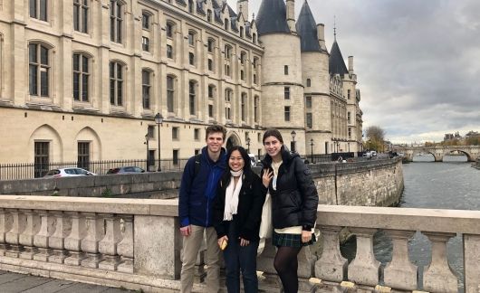 Gap year students group photo beside castle in Paris