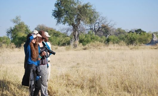 High school students with camera in grasslands of Botswana