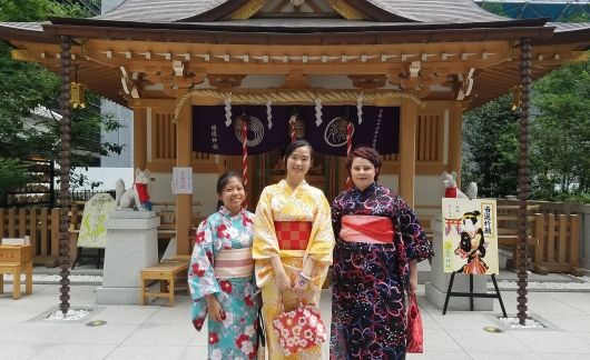 High school students in kimonos outside temple in Japan