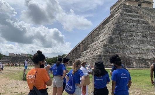 High school students looking at ancient pyramid in the Yucatan