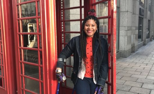 girl by red telephone booth in london