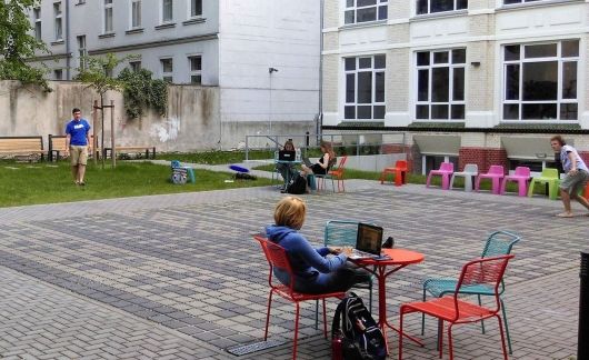 Teacher and students relaxing outside at the Berlin Global Institute