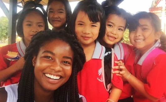 Teacher with group of kids in Thailand