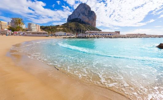 spain alicante beach with large rock mountain