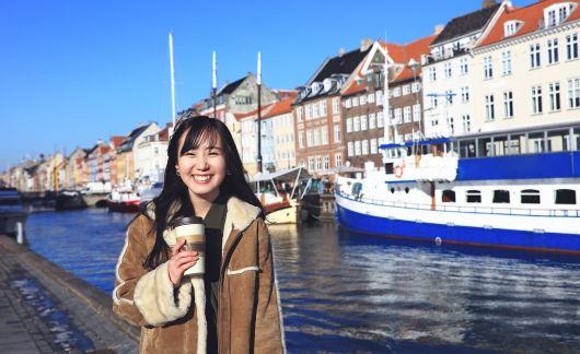 Copenhagen girl with coffee by river