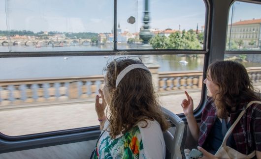 High school abroad students looking on a bus window at Prague